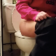 A girl is recorded pulling out a tampon, pissing and taking a shit while sitting on toilet in a bathroom at a home. The video was supposedly voyeuristically made of a girl visiting that day. Over a minute.